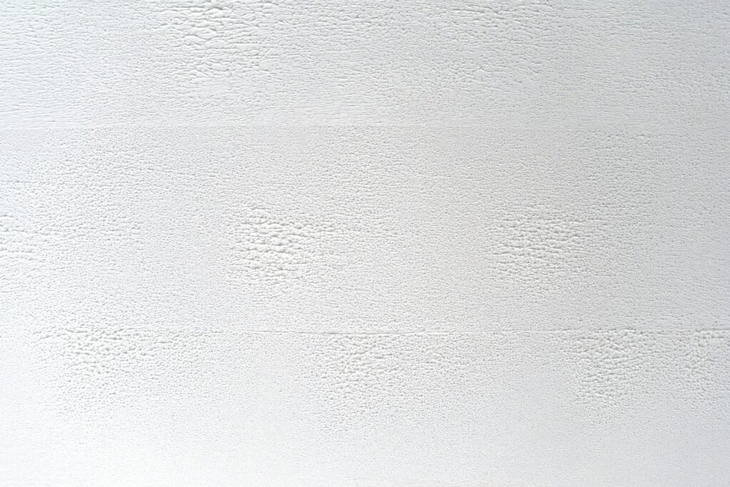 Close-up of a white textured wall, perfect for backgrounds or design elements.